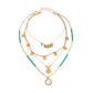Gold and turquoise layered bohemian necklace laid flat showing three strands