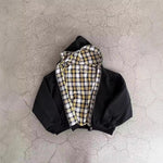 Black reversible zip hooded sweatshirt, solid black outer with a yellow tartan plaid reverse