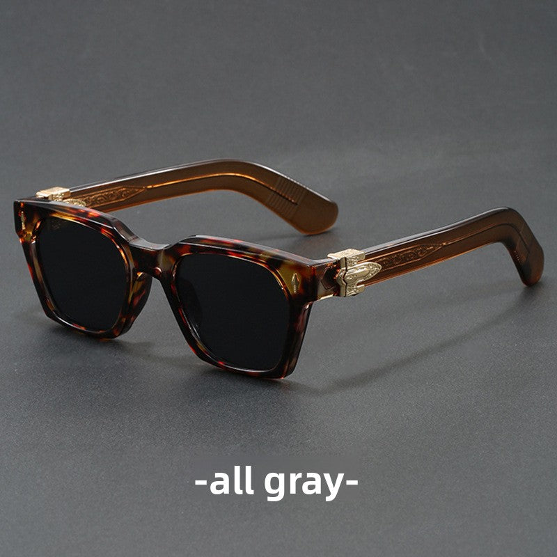 Emerald green square sunglasses with a blue gradient lens and gold arrow temple detail