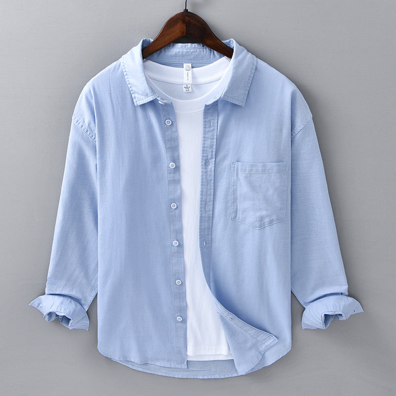 Natural beige shirt front with the collar left open over a tee