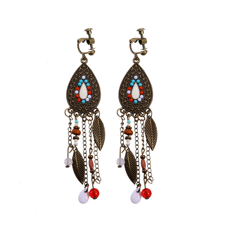 Boho vintage clip-on drop earrings with fringe and bead accents, zinc alloy build, studio image on white background
