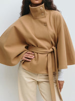 Khaki belted cape jacket with a buttoned stand collar and wide cape sleeves, belt tied at the waist