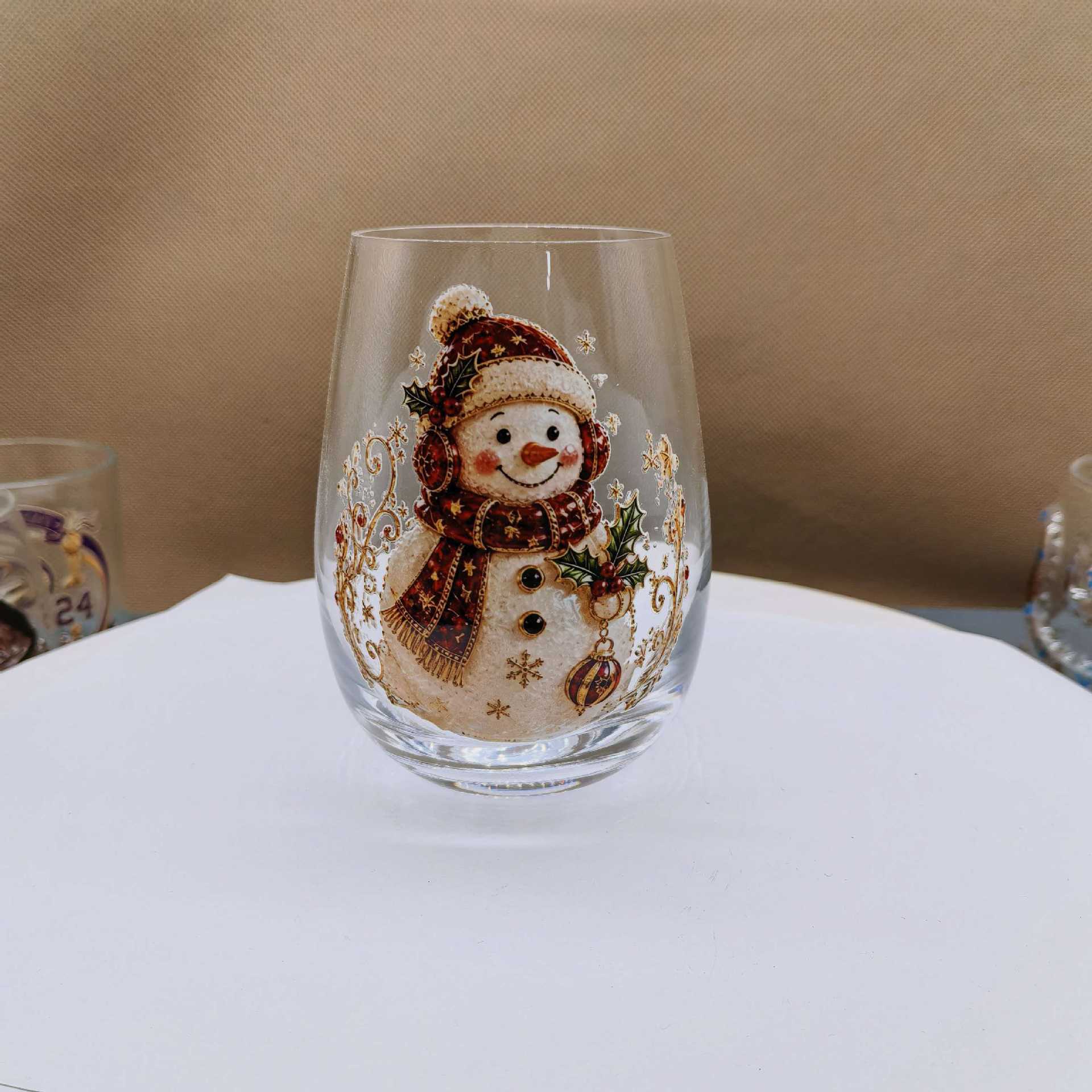 Clear borosilicate Christmas glass cup with a raised painted flat snowman holiday motif