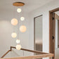 Sixteen head version of the globe chandelier over a tall void