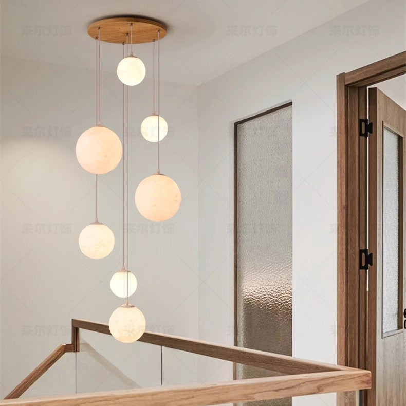 Sixteen head version of the globe chandelier over a tall void