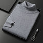 Men's slim-fit turtleneck sweater on a plain studio background