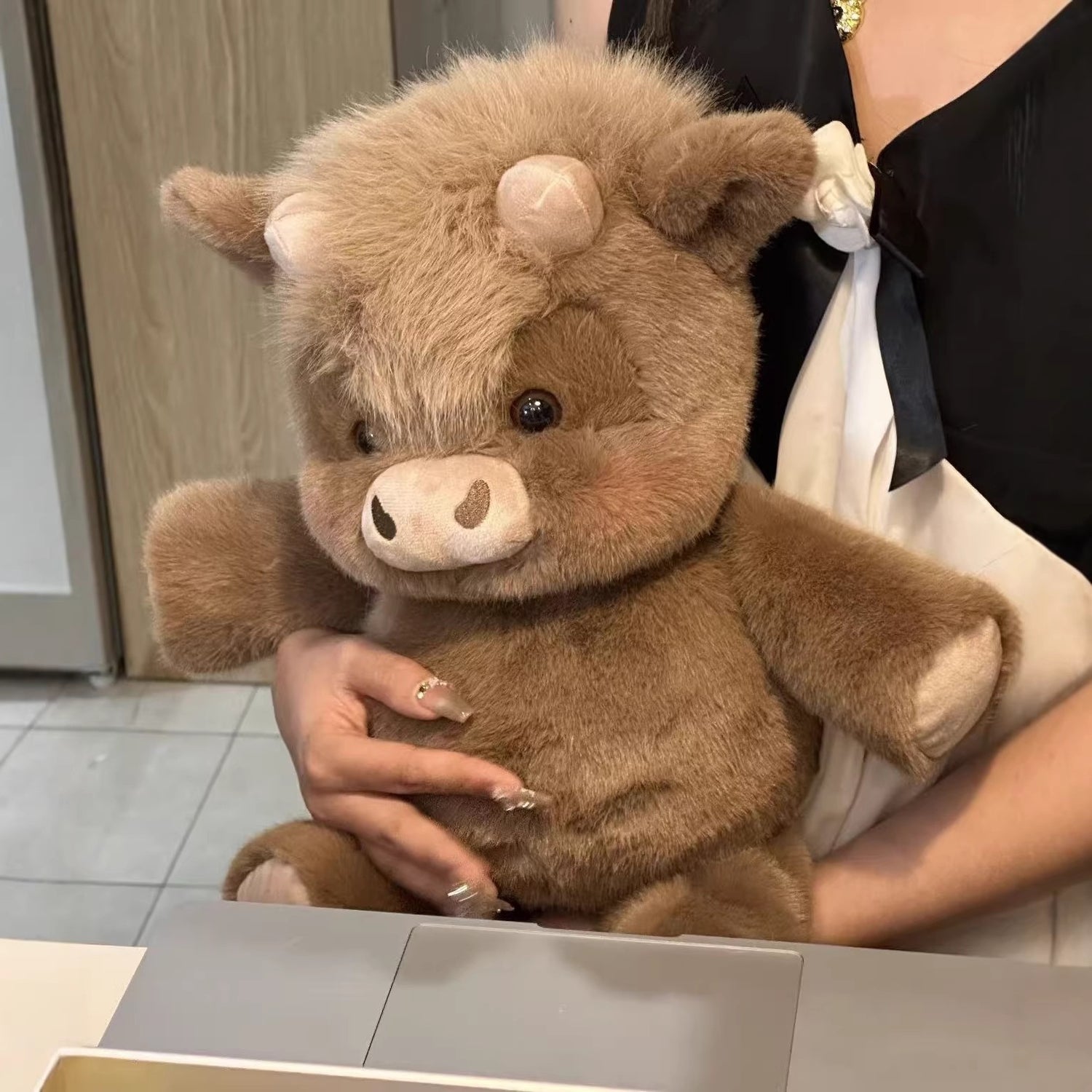 Soft plush animal cattle toy shown at an angle on a plain background
