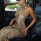 Back view of the leopard print maxi dress showing the open back to the waist
