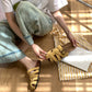 Woven slide sandals side view showing the sole and caged upper