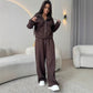 Brown zip front hooded sweatshirt with drawstrings held out and matching wide leg trousers worn by a model