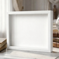Empty white shadow box frame with a plain white backdrop on a shelf, the Default option without a display