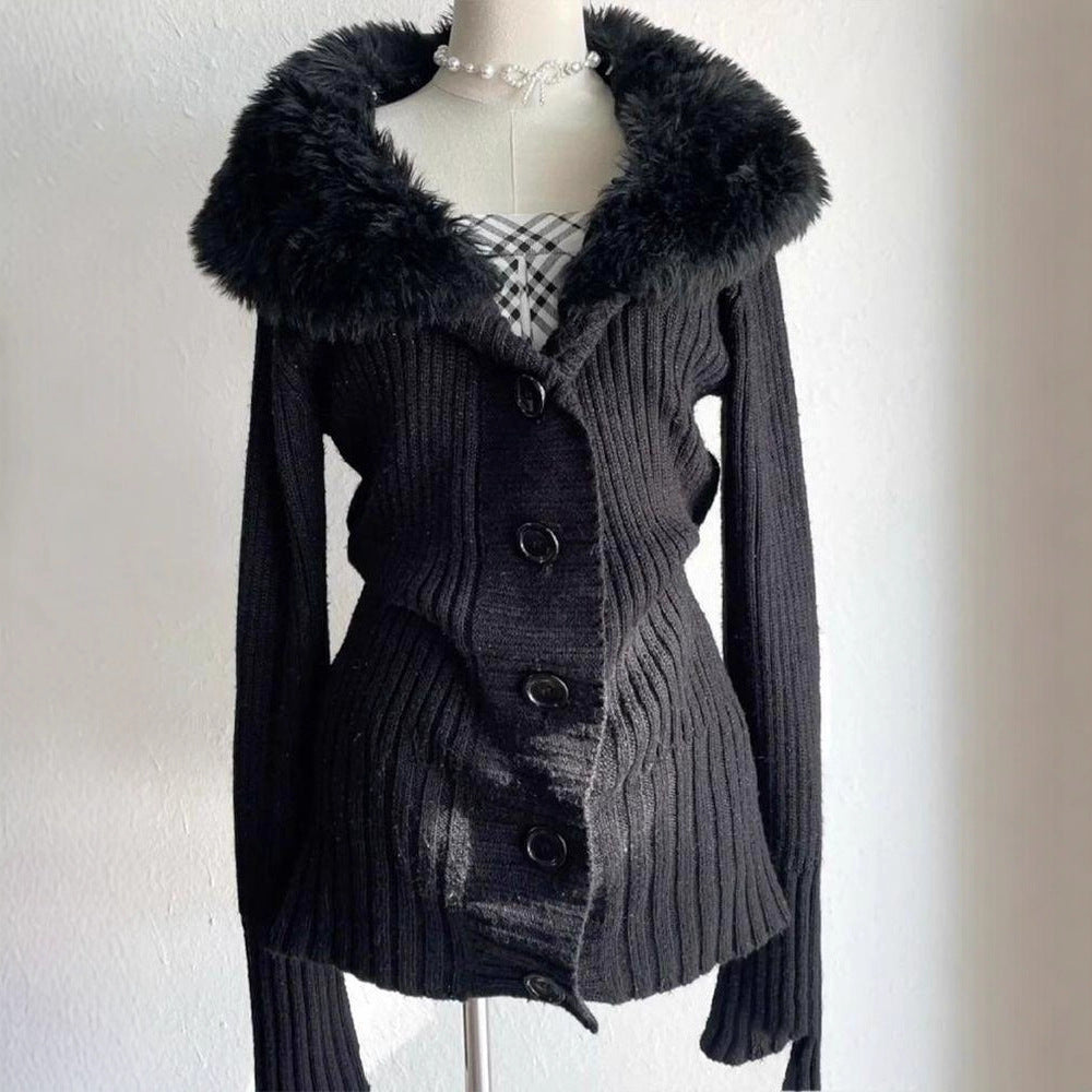 Black ribbed knit button cardigan with plush collar, seen from the front on a mannequin against a white wall