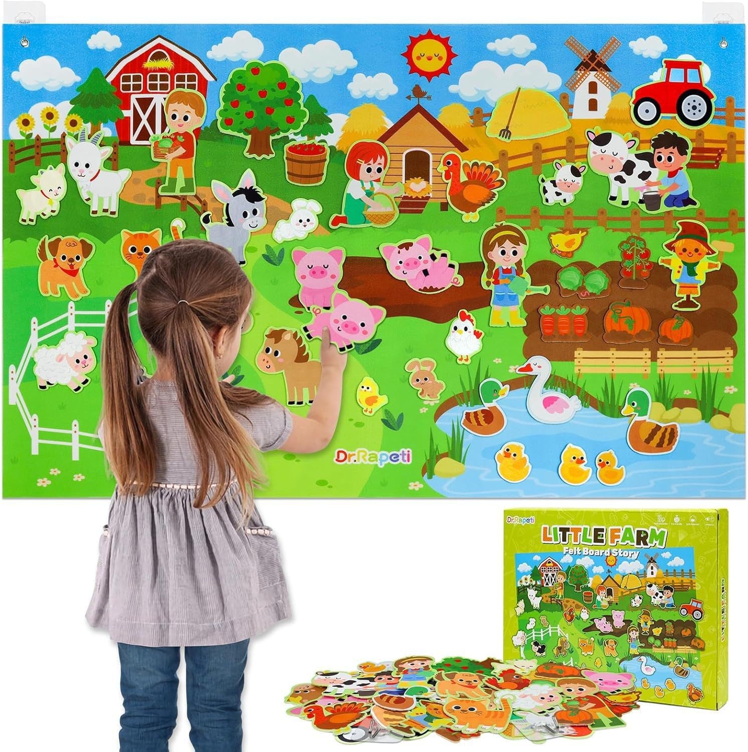Girl placing felt animals on a farm themed hanging felt story board beside its Little Farm gift box