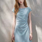 A-line cap sleeve ruched waist mini dress in soft stretch knit, side view showing the ruched waist and A-line skirt