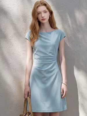 A-line cap sleeve ruched waist mini dress in soft stretch knit, side view showing the ruched waist and A-line skirt