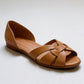 Woven peep toe flat with interlaced leather straps across the instep