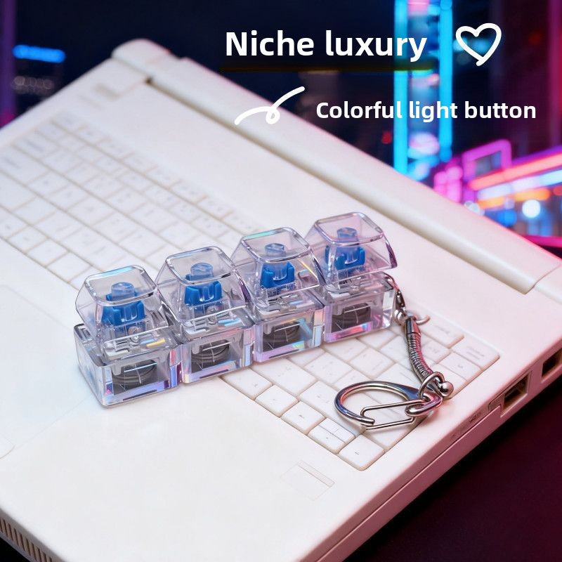 Nine key transparent keycap grid clicker glowing in color, held in a hand
