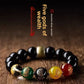 Five-Way God of Wealth obsidian look bracelet shown on plain background