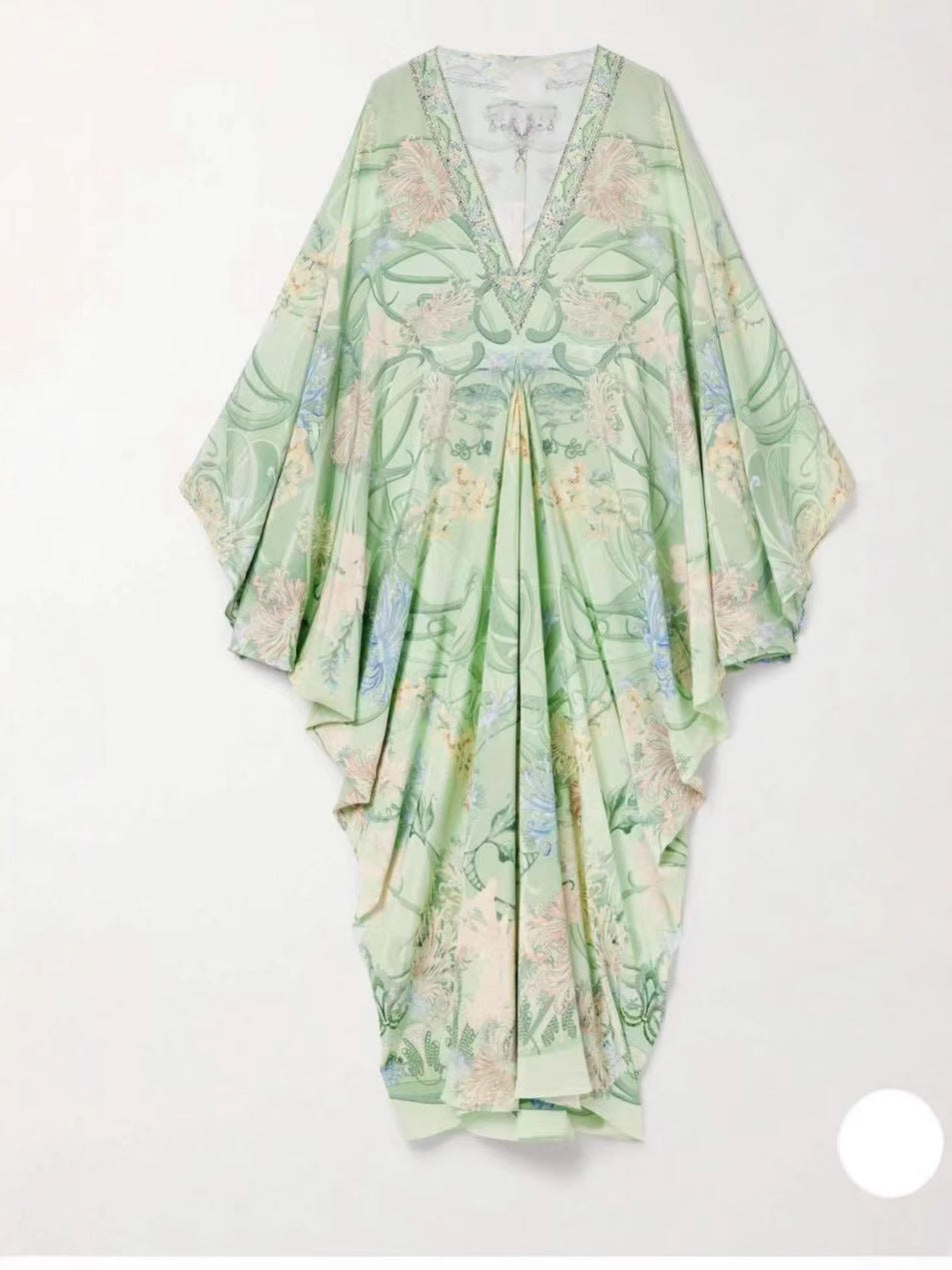 Light green floral V-neck dress laid flat showing the wide sleeves and the trimmed neckline