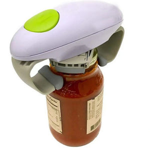 White electric automatic jar opener with a green button gripping the lid of a tomato sauce jar