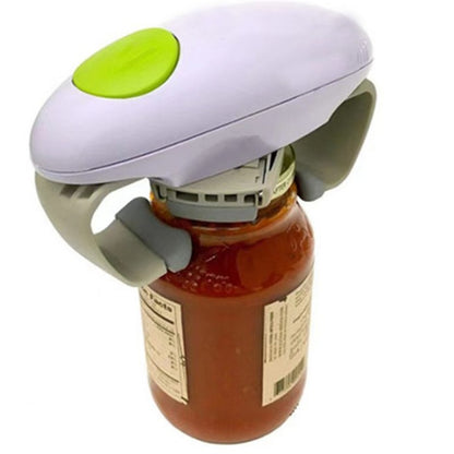 White electric automatic jar opener with a green button gripping the lid of a tomato sauce jar