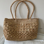 Raffia hand-woven tote bag in soft studio light, natural fiber texture
