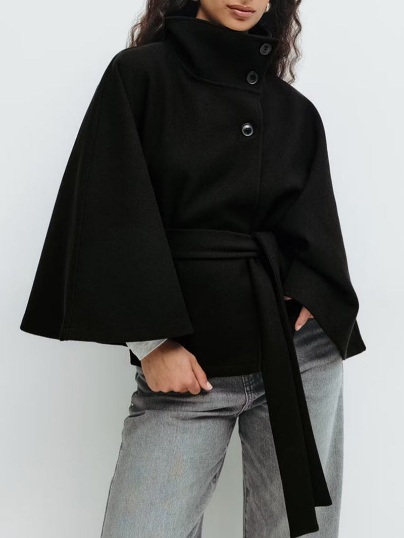 Belted cape jacket shown from the front with its self tie belt and stand collar buttons