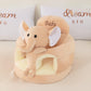 Beige plush baby floor seat with an elephant at the front and a padded seating ring