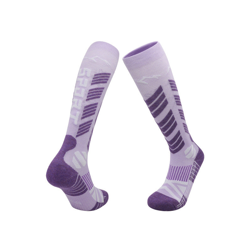 Sport ski socks knit with contrast panels and a plush cushioned sole on a white ground