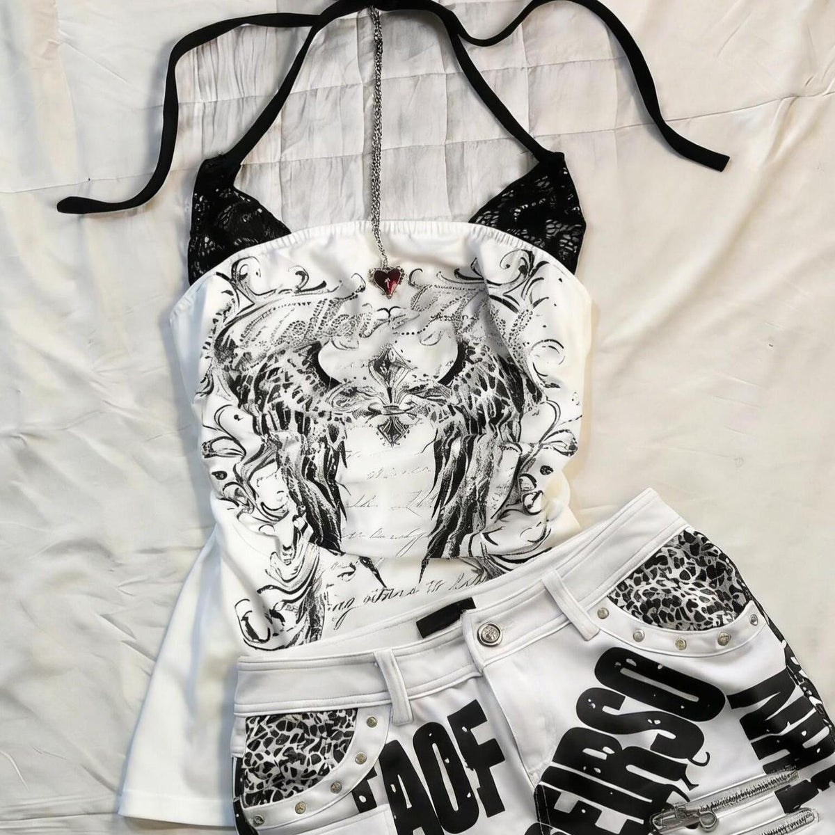White halter top with black wing print and lace shoulders, shown on the White size M option