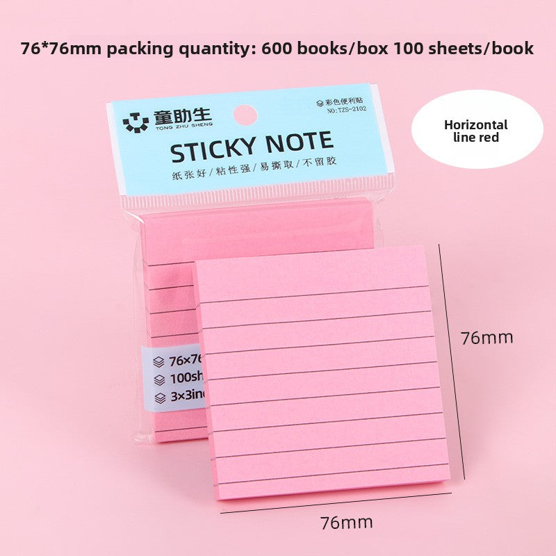 Lined sticky note pads in several pastel colours arranged in a row on a desk