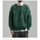 Man wearing a green whale jacquard knit sweater with white inner layer, size L option