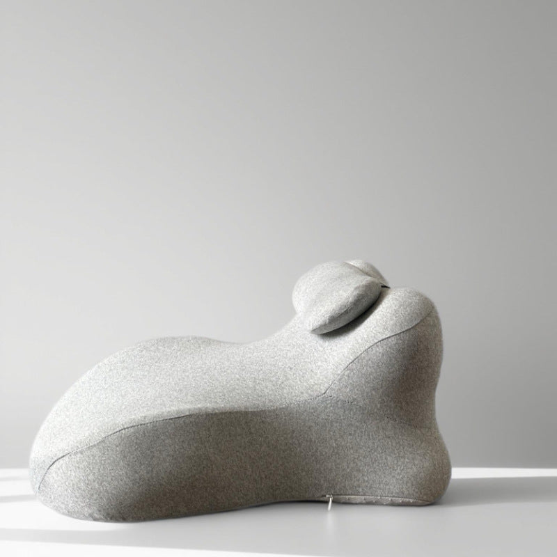 Light gray back cushion in profile on a grey ground, neck roll seated in the valley