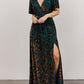 Floral velvet maxi dress shown from the front with the thigh high side slit open over one leg