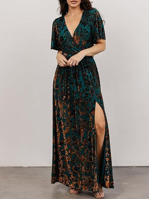Floral velvet maxi dress shown from the front with the thigh high side slit open over one leg