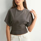 Highlight of the ruched waist detail that shapes the loose batwing sleeve casual top
