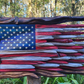 Rustic wooden American flag wall art shown on a plain background
