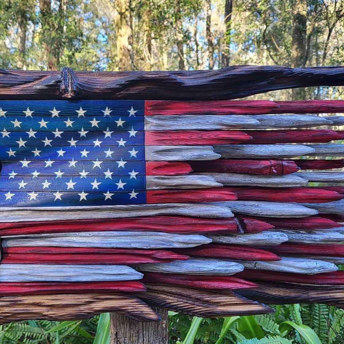 Rustic wooden American flag wall art shown on a plain background