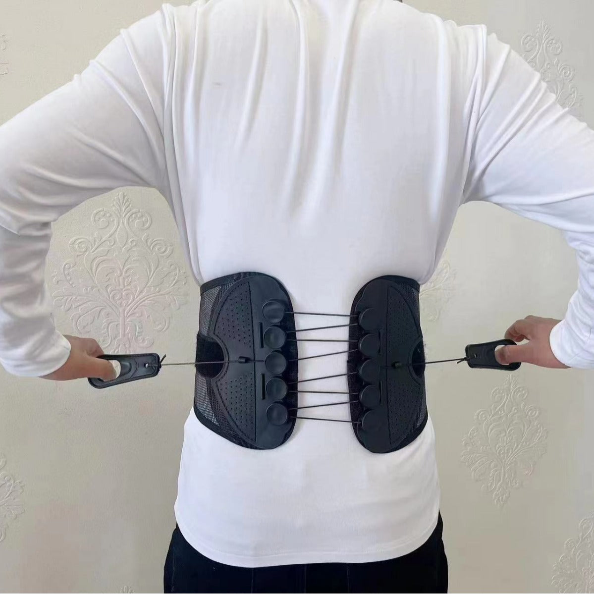 Person pulling the two side handles to cinch the back belt snug