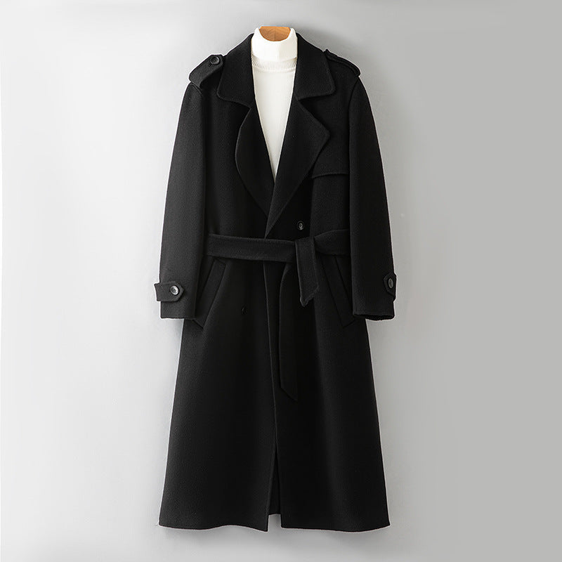 Black wool overcoat lapel and button trim shown in close detail