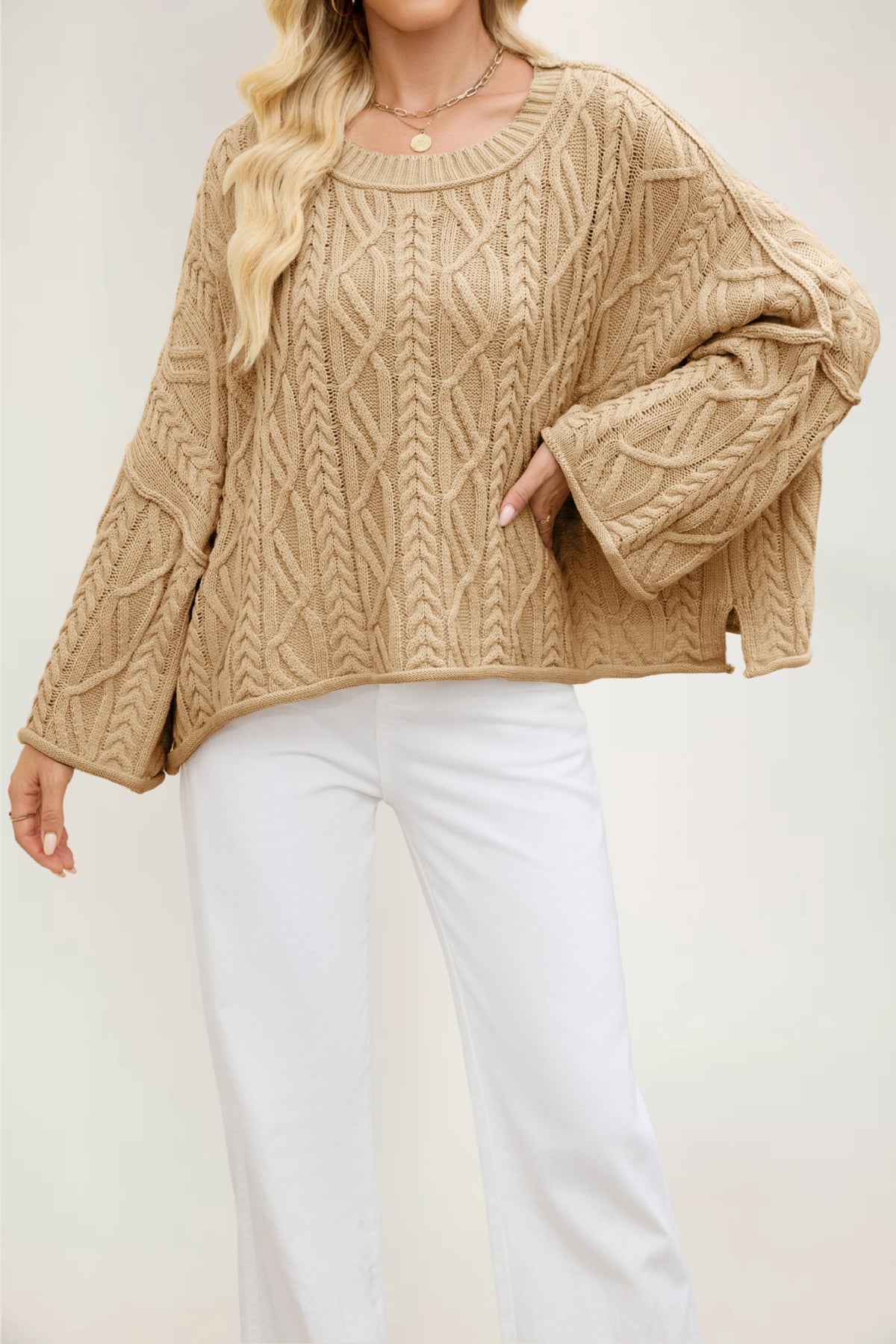 Loose fit knit sweater with rolled neck and cuffs and long flared cable knit sleeves