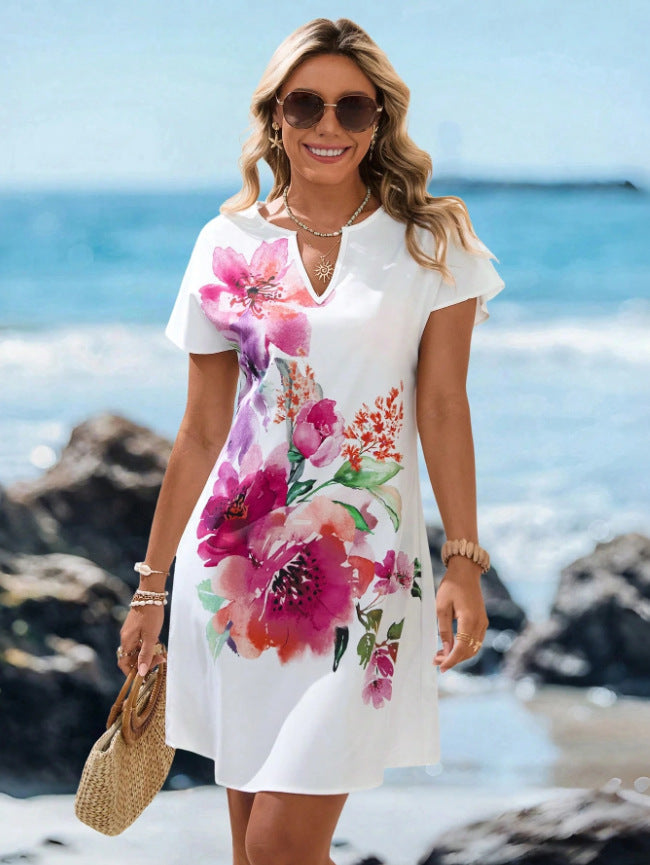 V-neck starfish and seahorse print A-line beach dress, styled with a straw bag and sandals