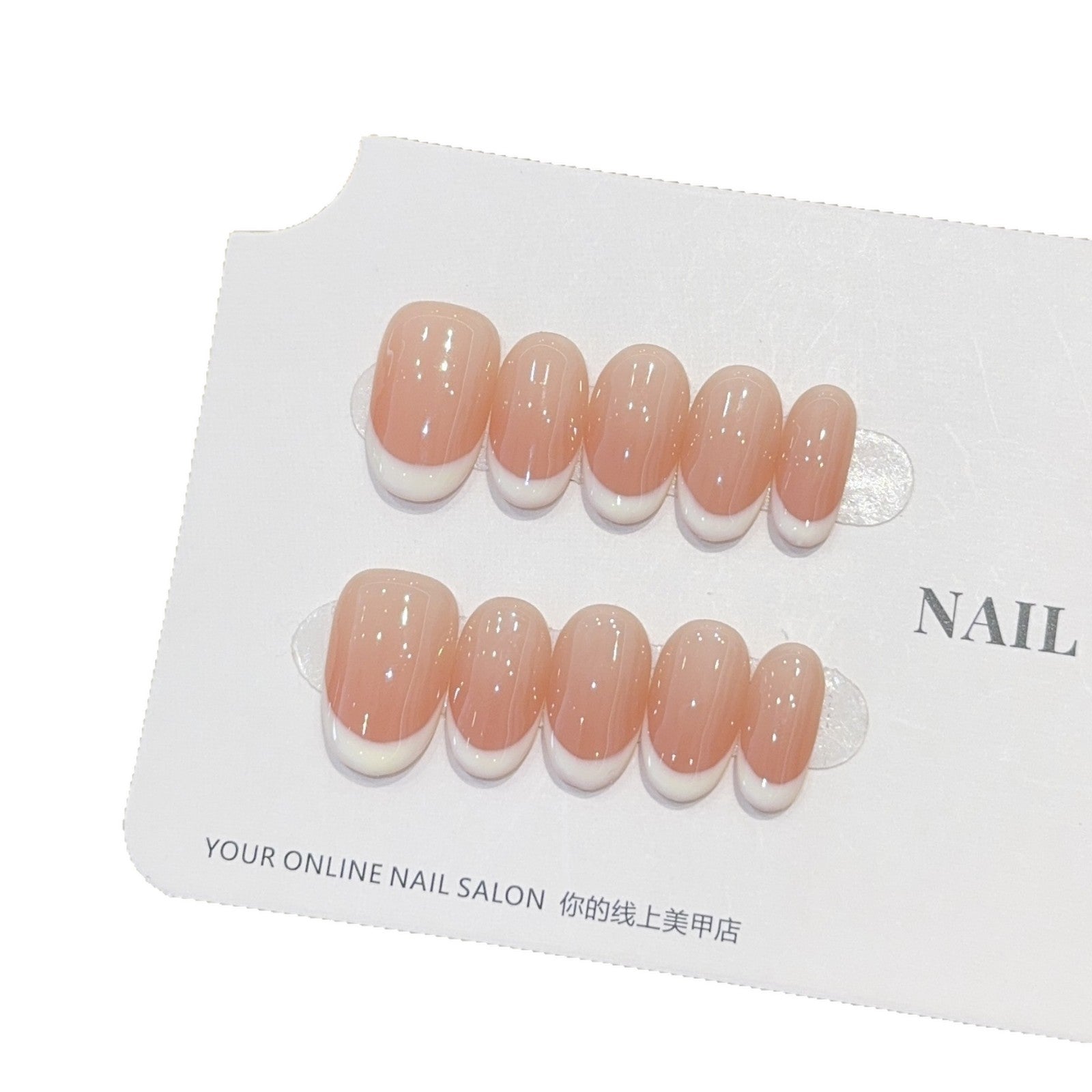 Peach milk press-on nails being applied to a natural nail