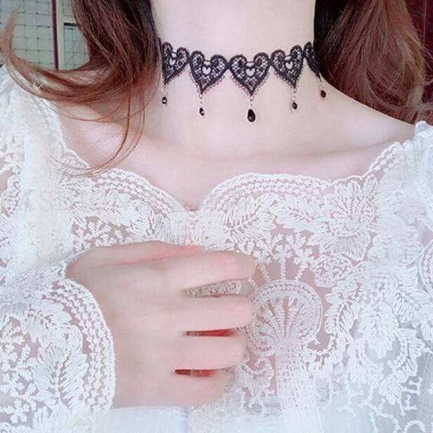 Lace choker necklace with an alloy filigree centre and small dangling beads