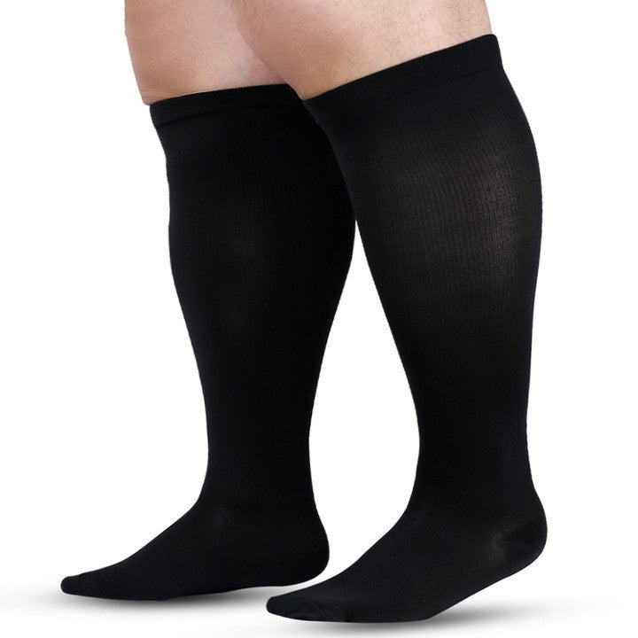 Plus size knee high sock shown on the leg to show the wide calf and cuff fit