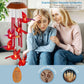 Red bird wind chime with red tubes and a wooden pendant on a sympathy gift banner with two women on a sofa