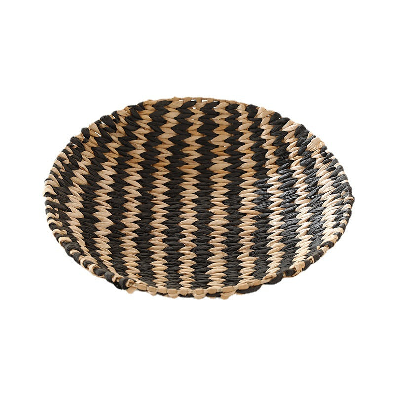 Nordic hand-woven straw wall decor disc showing a tight coiled spiral face