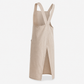 Hand sliding a notebook into the deep front pocket of the apron