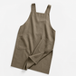 Apron over a chef coat behind the line during a busy dinner service