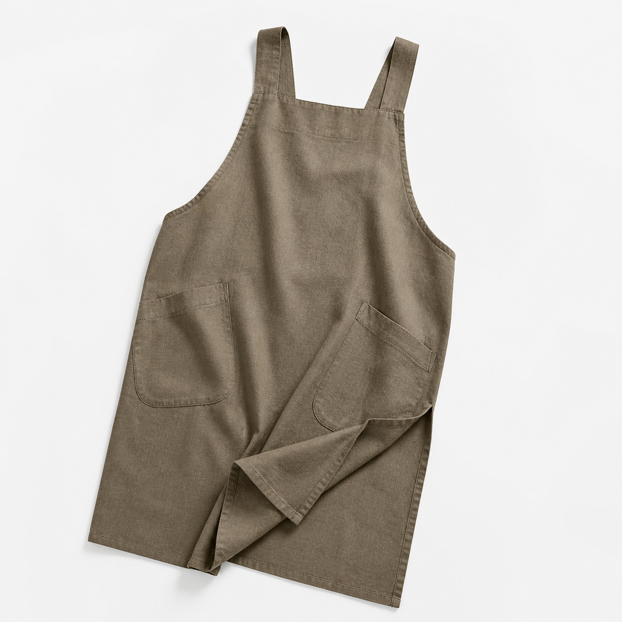Apron over a chef coat behind the line during a busy dinner service